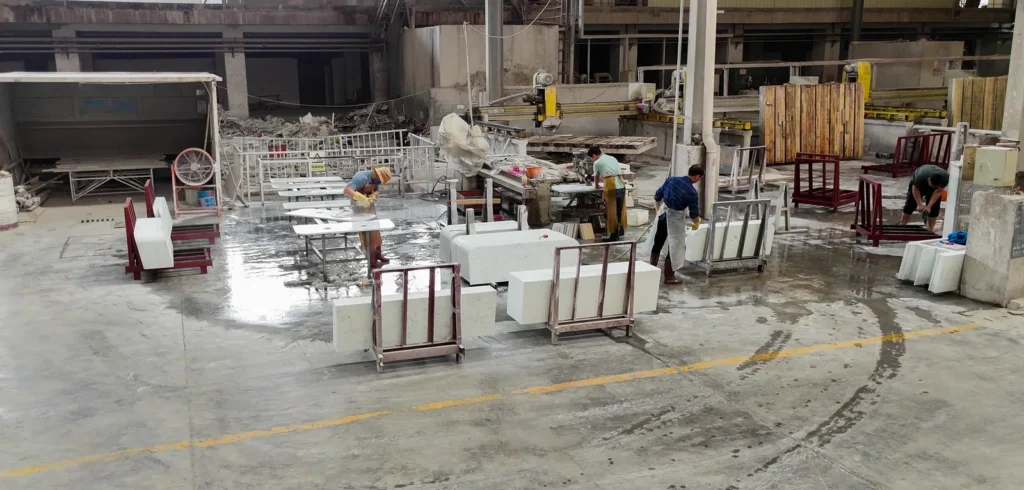 Workshop where we cut each marble table top and stone countertop to size, with A-frame racks of finished pieces