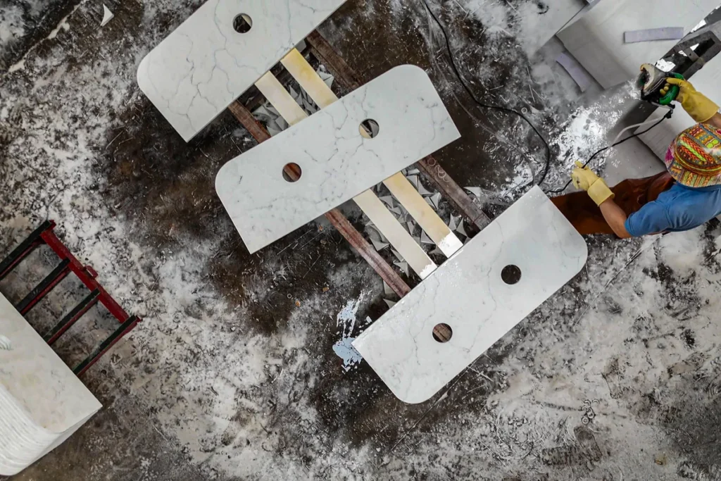 Countertops cut to size with sink openings, on racks in the G-Stone workshop