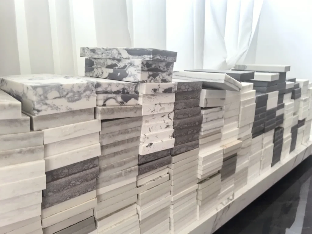 Hand samples in different colours and patterns stacked in our showroom