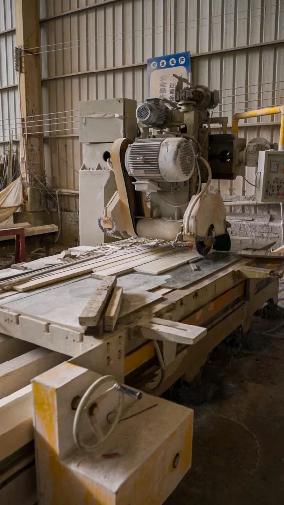 Saw cutting stone strips to width in the fabrication workshop